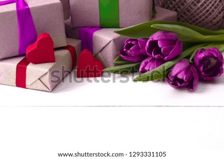 gift boxes with flowers on white wooden background