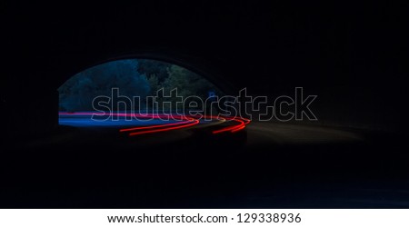 ight trails in tunnel. Art image . Long exposure photo taken in a tunnel