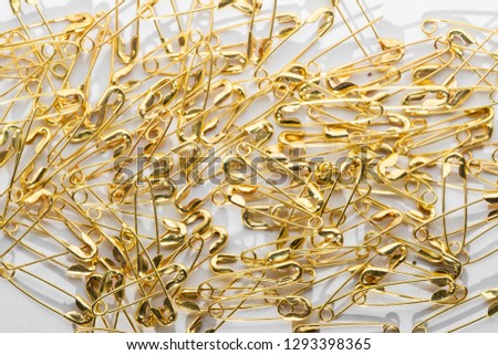 golden pins on white background