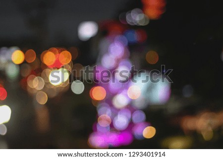 Abstract Bokeh light from defocus image of Road in Night time with bokeh for background usage blurred background. Night city lights blurred film vintage tone.