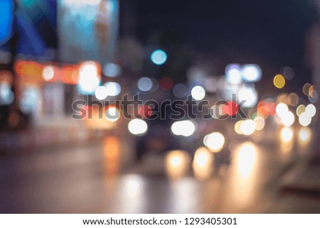Abstract defocus blurred image of Road in Night time with bokeh for background usage blurred background. Night city lights blur film vintage tone.