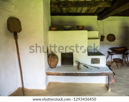 Old clay oven from Maramures county. Interior of a traditional house from Apuseni Mountains. Past life in the country in Romania. Transylvanian traditional old interior house in the countryside.  Royalty-Free Stock Photo #1293436450