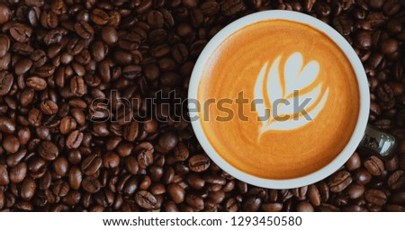 a coffee latte and coffee beans roasted background