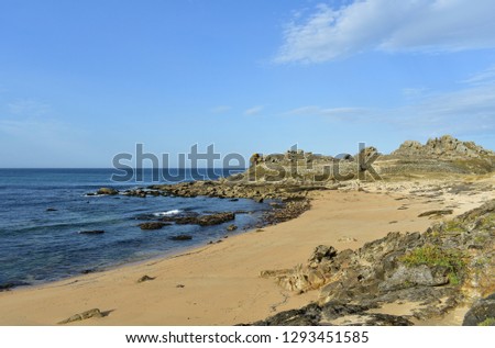 Castro de Baroña, Galicia, Spain. Prehistoric settlement ruins and beach with rocks. Blue sea, sunny day.