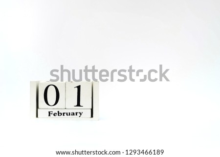 close up wooden calendar on white background, 1 february text 