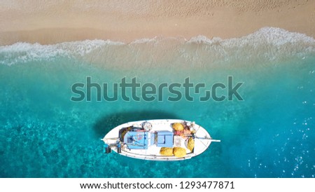 Aerial photo from traditional picturesque fishing boat on turquoise clear sea as seen from top in island of Paros, Cyclades, Greece