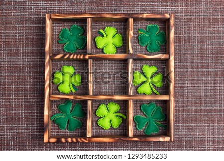 Felt four-leaf clover in the wooden box on sackcloth and cell copy space. Lucky shamrock, St.Patrick's day holiday symbol. Space for text, top view.