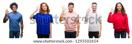 Composition of african american, hispanic and caucasian group of people over isolated white background smiling positive doing ok sign with hand and fingers. Successful expression.