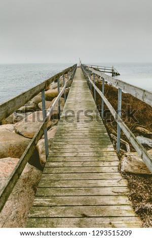 Wooden pier on the sea, in Sweden Scandinavia North Europe. Dramatic concept