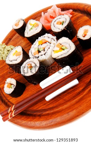Japanese Cuisine : Sushi Maki Roll with Salmon and tuna inside . on wooden plate with wasabi and ginger isolated over white background