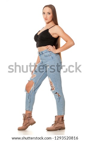 young woman with very long hair and jeans on white background