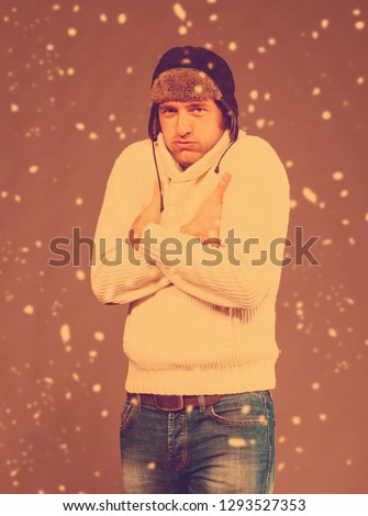 Picture of handsome man in warm sweater and hat. Intentional color shift