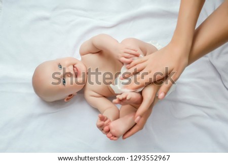 Mother cleaning up and wipes body and leg baby by wet tissue. Cleaning wipe, pure, clean. happy emotions of newborn baby. Royalty-Free Stock Photo #1293552967