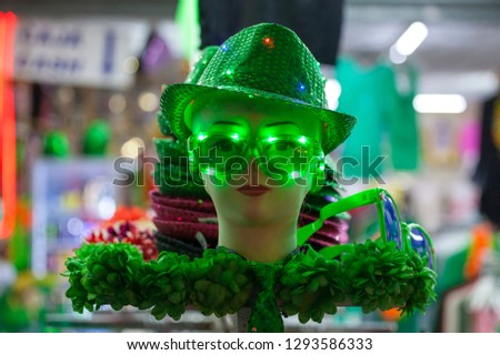 Mannequin in green glasses and hat. Green glasses. Green hat. Shiny hat. St.Patrick 's Day. Celebration. Clover. Carnival. Irish holiday. Saint Patrick.