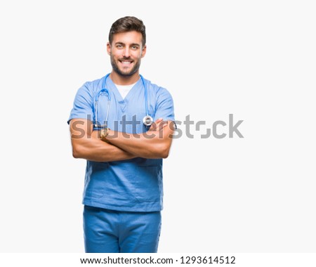 Young handsome doctor nurse man over isolated background happy face smiling with crossed arms looking at the camera. Positive person.