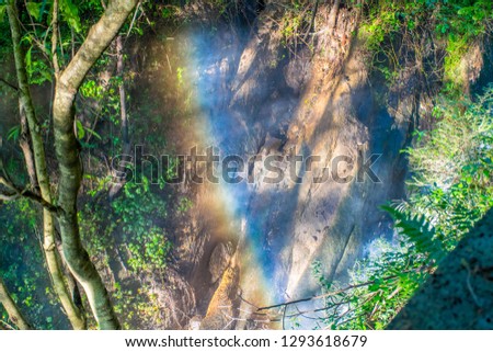 The misty sunlight rainbow over the huge Dieshuihe waterfall in Tengchong area, Yunnan province, China.