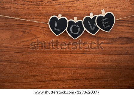 Heart shape chalkboard on wooden background