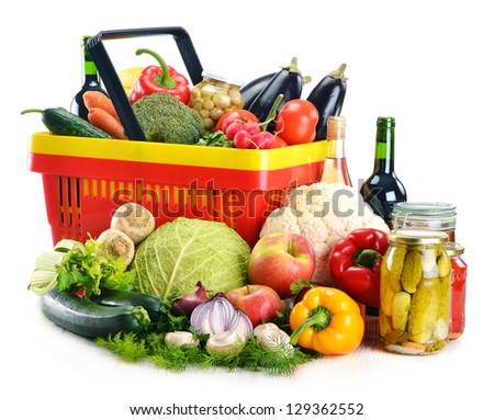 Composition with plastic shopping basket and grocery isolated on white