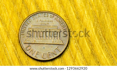 Close up picture of single American one cent on a wooden background.