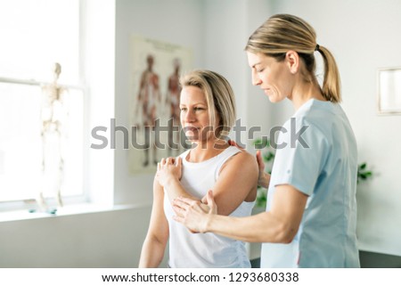 A Modern rehabilitation physiotherapy worker with woman client Royalty-Free Stock Photo #1293680338
