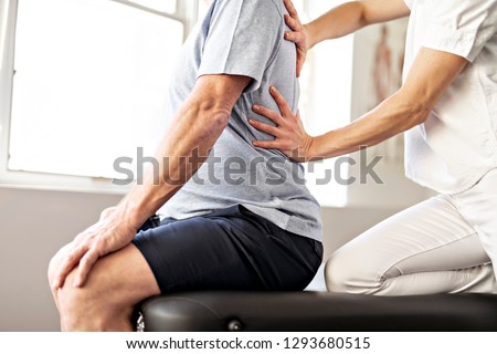A Modern rehabilitation physiotherapy worker with senior client Royalty-Free Stock Photo #1293680515