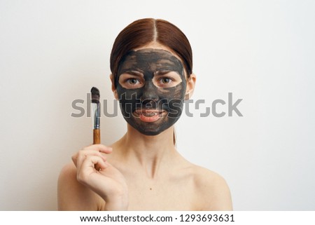 woman in clay mask care spa facial treatment
