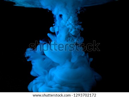 acrylic color paint in water. burst of color on black background