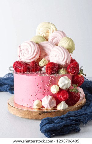 Birthday cake with meringue and berries. Delicious dessert for children. Light white background