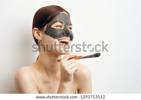 young woman laughs on face mask cosmetic clay care