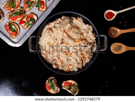 fried rice into cauldron, snacks on tray, spoons with spices
