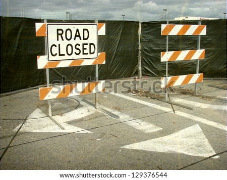 aged and worn vintage photo of  road closed barricades