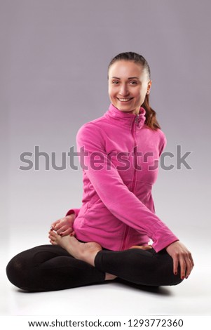 Sporty young woman doing yoga practice isolated on blue background. Concept of healthy life