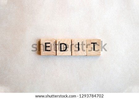 The word Edit written on wooden blocks on a white back ground. Black letters on square wood blocks. Business and education concepts