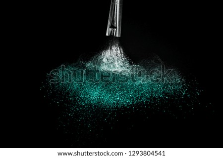 Cosmetic brush with Deep ocean  cosmetic powder spreading for makeup artist or graphic design in black background