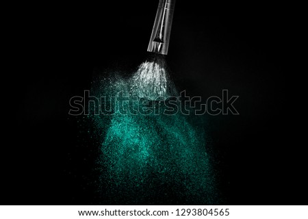 Cosmetic brush with Deep ocean  cosmetic powder spreading for makeup artist or graphic design in black background