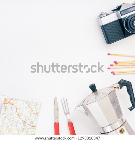 Creative Top view flat lay outdoors trip composition. Thermos map retro camera cutlery blanket white background copy space. Square Template weekend outing picnic nature tourism recreation