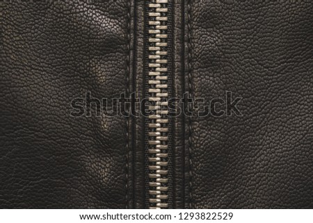 Zipper, lightning on black leather
