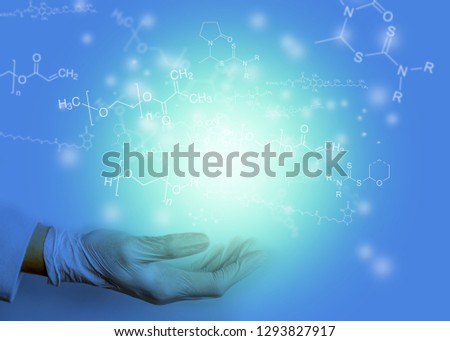 hand with light and chemical formulas background - chemist working and present ideas concept