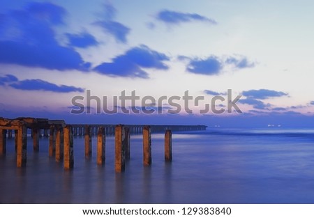 Broken Pier during sunrise on a winter day