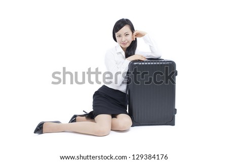 young business woman sitting on the floor with suitcase, isolated on white background