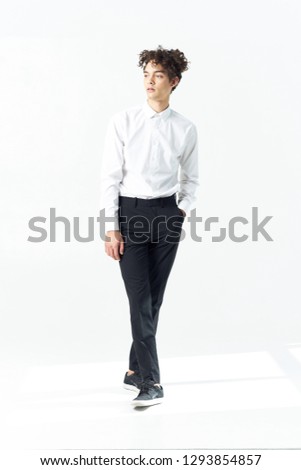 Business man in a white shirt in a full-length office worker on a light background