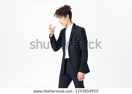 A business man in a dark suit. Office worker on a light background, sneers