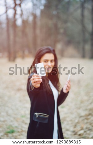 Attractive woman with credit card shopping online in the park