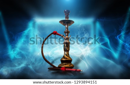 Smoking hookah on the background of an empty room, neon light, smoke