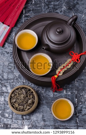 Traditional Asian tea ceremony. Ceramic accessories and dry tea leaves. Selective focus.