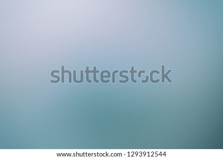Smooth flat vintage paper bag pale texture in light blue color on table background. 