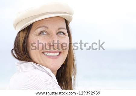 Portrait happy attractive mature woman enjoying active retirement and healthy lifestyle, isolated with white blurred background outdoor.