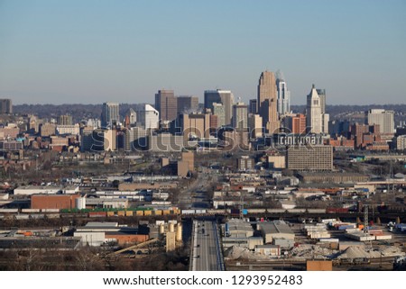 The Cincinnati, Ohio, USA skyline is shown from a wide, elevated view on a winter afternoon day.