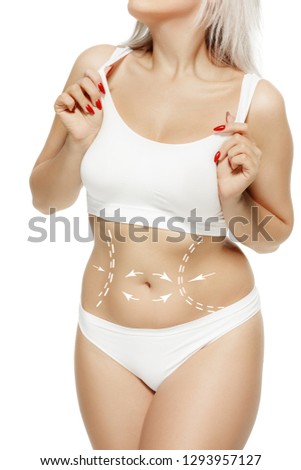 Female body with the drawing arrows. Fat lose, liposuction and cellulite removal concept. Marks on the women's buttocks, waist and legs before plastic surgery. The concept of plastic surgery