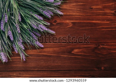 Object photography of a notepad on a wooden background with flowers.